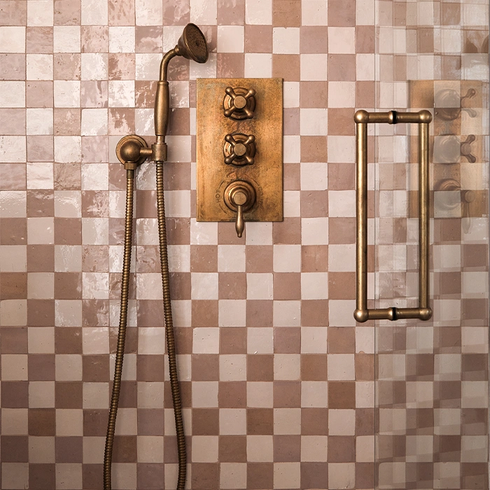 Shower wall featuring zellige chequerboard pattern in beige and brown